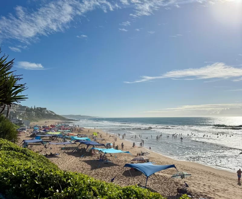 Willard Beach in Ballito with umbrellas and swimmers