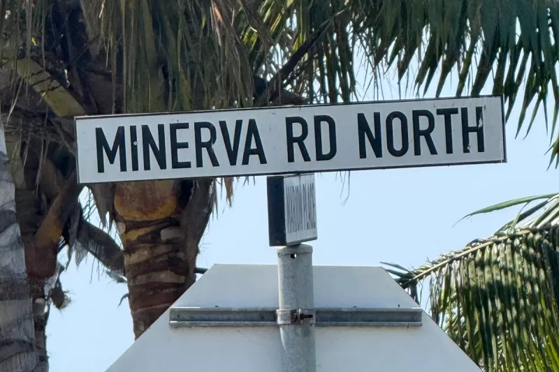 Minerva Road North street sign in Ballito with palm trees